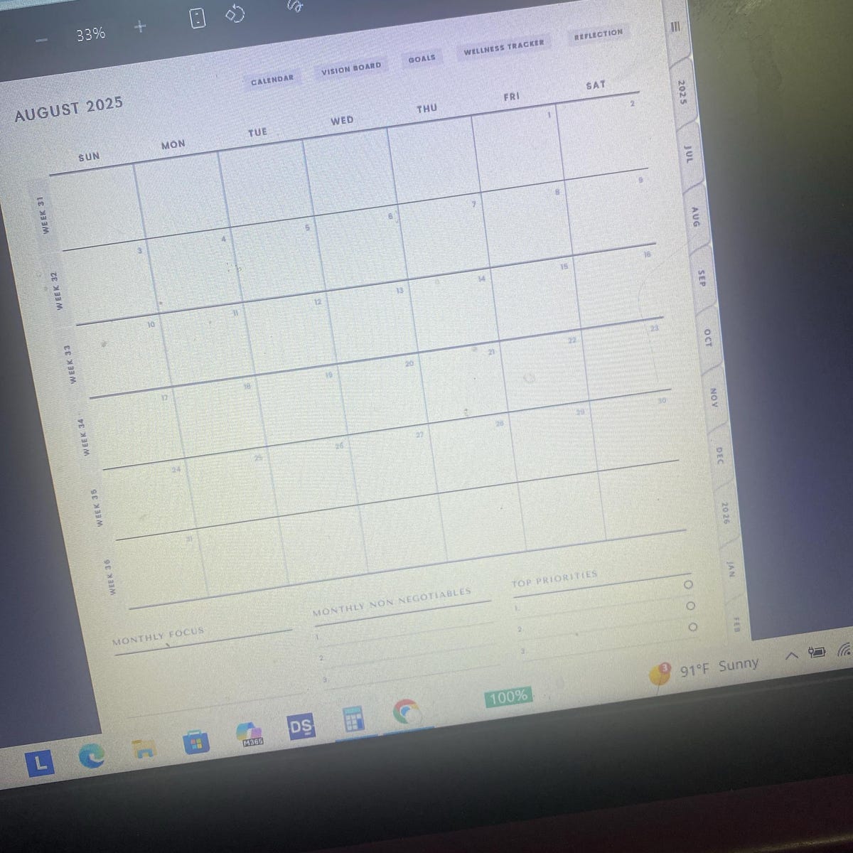 The MindTidy monthly calendar page open on a laptop screen